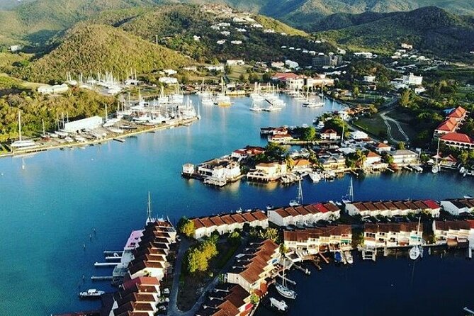 Yachts moored below the green hills of English Harbour, Antigua